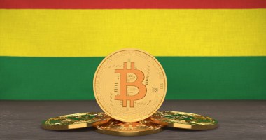 Moeda de Bitcoin à frente de bandeira da Bolívia