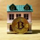 Modelo de casa com uma moeda de bitcoin