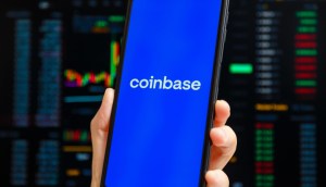 celular com logo da coinbase com graficos no fundo