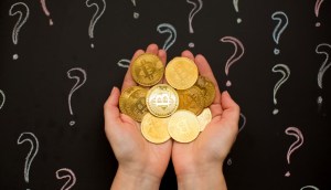 moedas de bitcoin em mãos com pontos de interrogação ao fundo