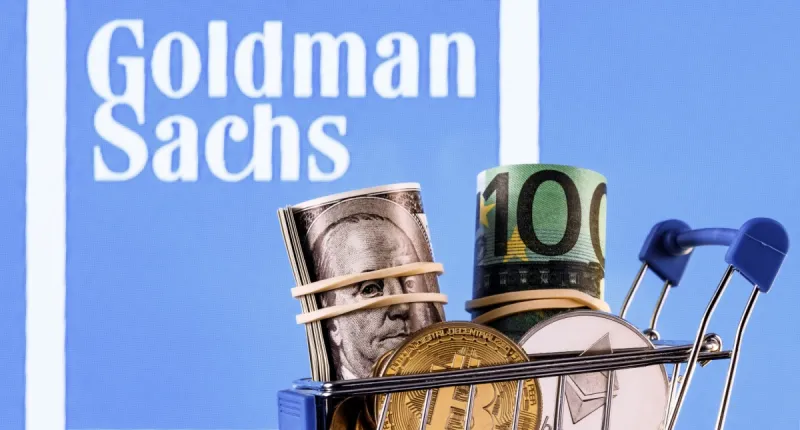 carrinho de compras com criptomoedas e dinheiro; ao fundo, logo do Goldman Sachs